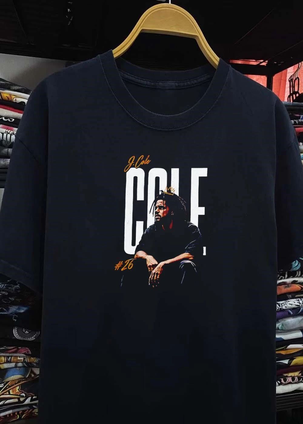 J Cole 26 Seated Rapper Wearing Small Gold Crown Distressed Background shirt
