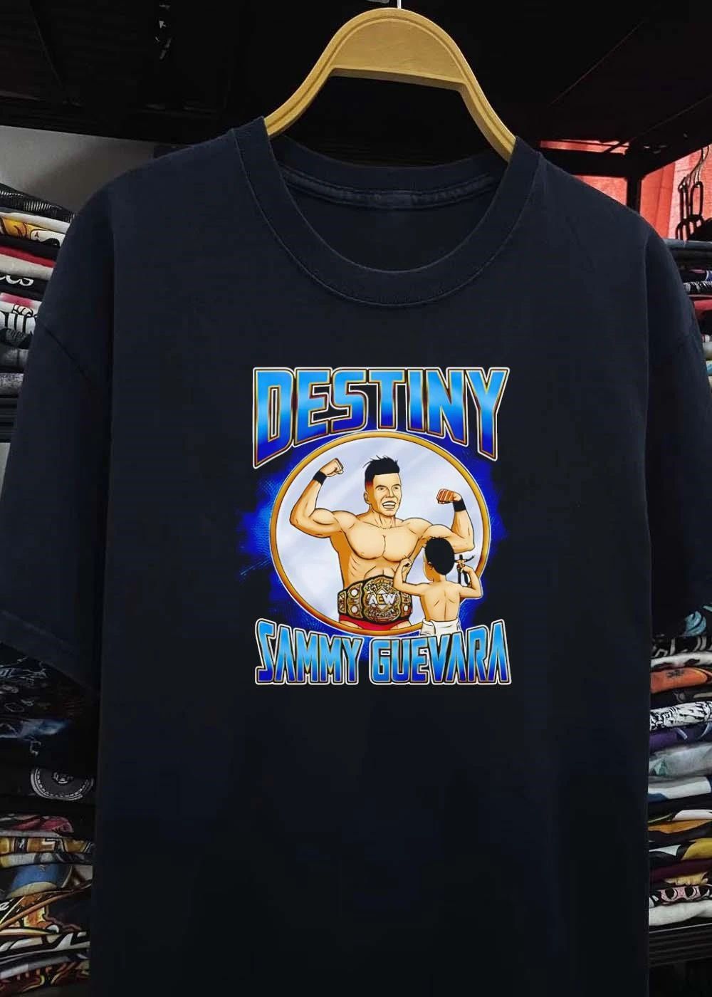 Destiny Sammy Guevara flexing with baby holding wrestling action figure shirt