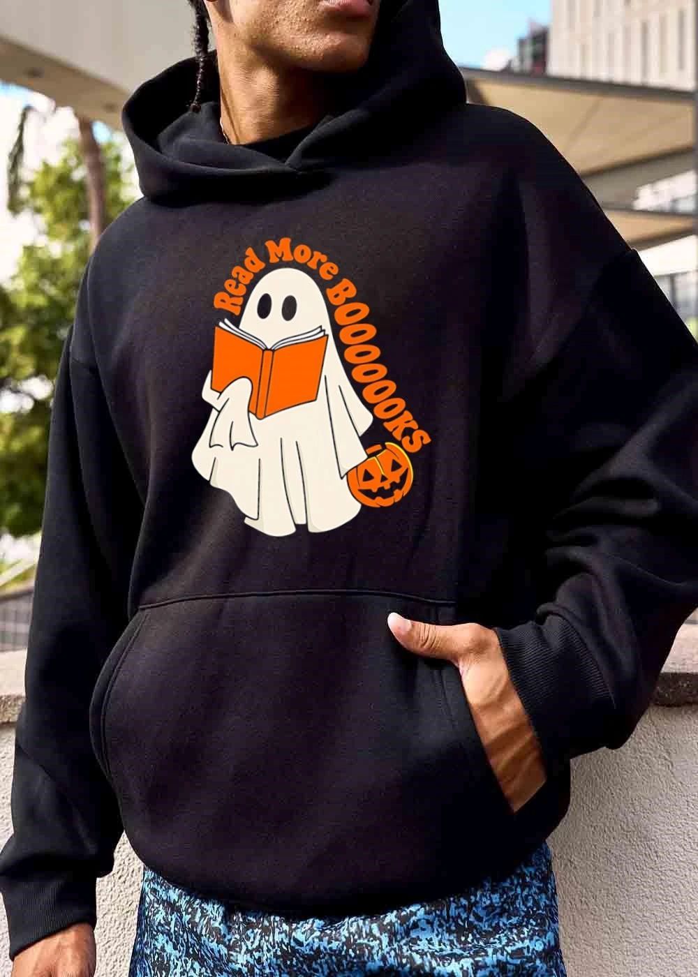 Read More Booooooks Cartoon Ghost Holding Orange Open Novel Pumpkin Bucket shirt